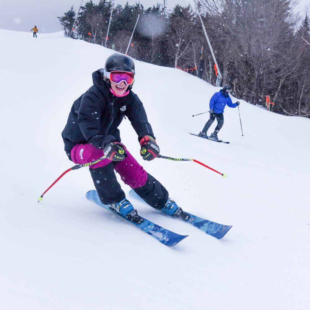 A women skiing in a Private Lesson with an instructor. 