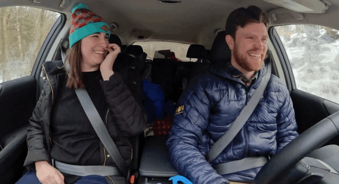 A family in a car, packed up to head to the Ski Resort.