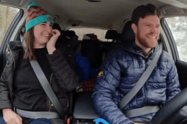 A family in a car, packed up to head to the Ski Resort.