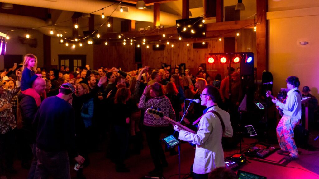 A band playing Gate House Lodge on New Years Eve, with a party dancing in front