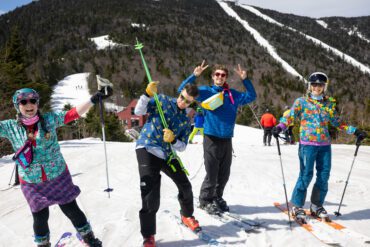Friends taking a break to smile on a sunny day of skiing