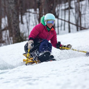 Adaptive skier on groomer